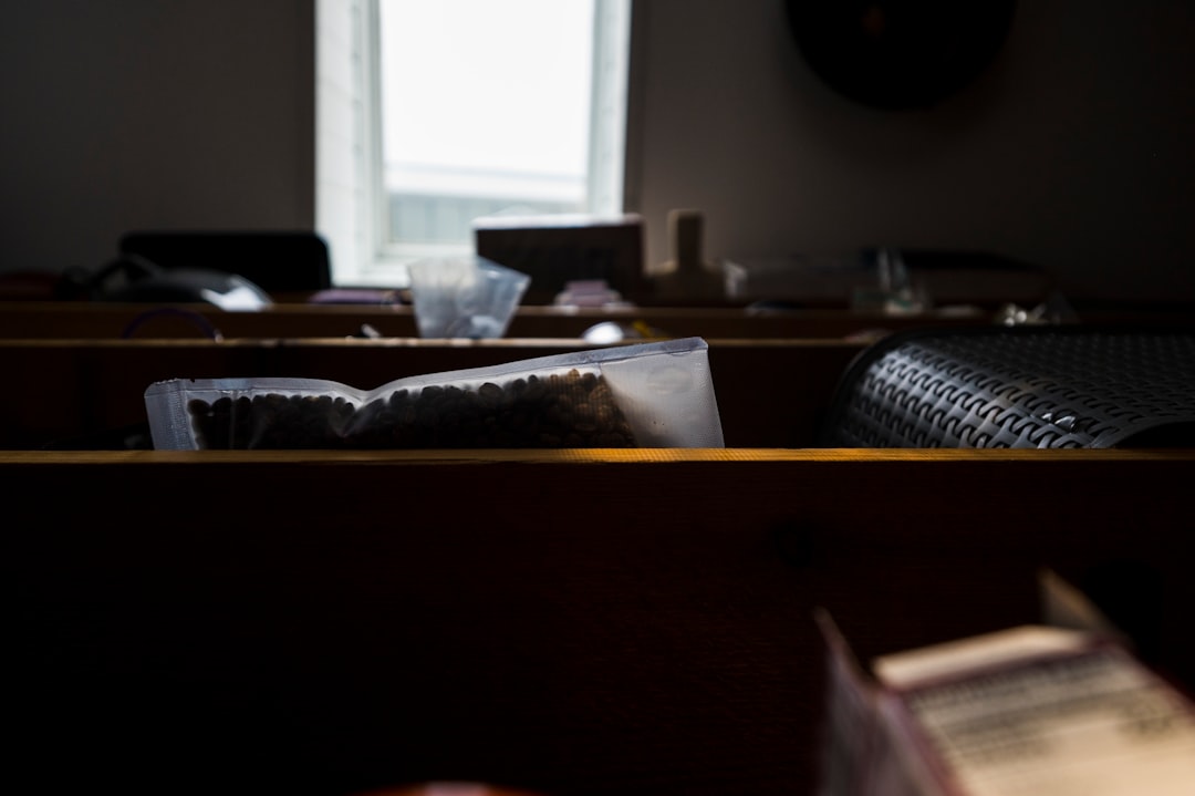a row of pews in a church with a window in the background
